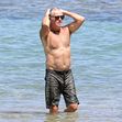 EXCLUSIVE: Pierce Brosnan takes off his shirt and takes a dip while in Hawaii