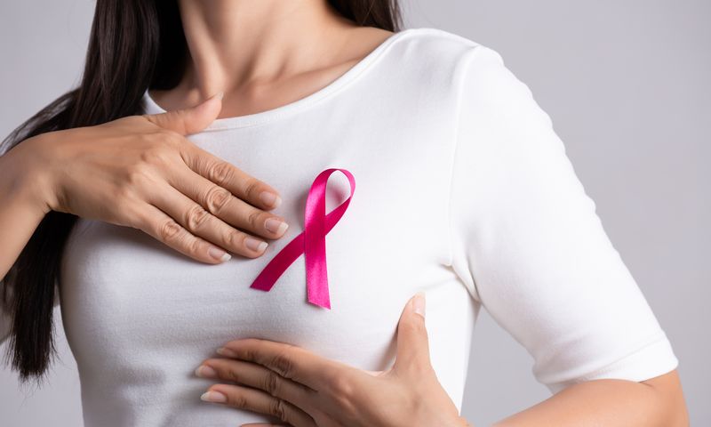 Closeup,Of,Pink,Badge,Ribbon,On,Woman,Chest,To,Support