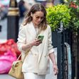 *EXCLUSIVE* British actress Emilia Clarke cuts a stylish figure in a Beige shoulder-padded jacket with a matching beige skirt as she's seen out and about in Soho, London.