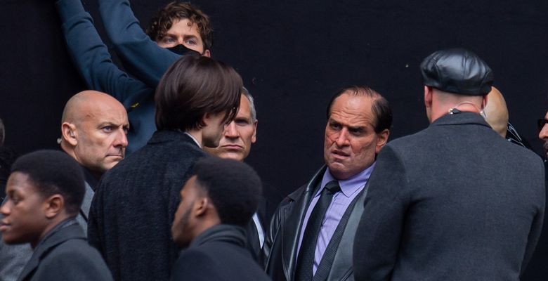 Robert Pattinson and a unrecognizable Colin Farrell are seen on the film set of Batman.