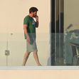 Ben Affleck looks right at home as he steps out on the balcony to smoke a cigarette wearing a Green Monstah while enjoying his Miami getaway with Jennifer Lopez