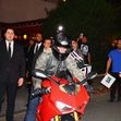 Tom Cruise rides out of a party at Sunset on a red Ducati