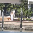 JLo is ethereal in white while Ben Affleck puffs on a cigarette as couple relax at lavish Miami Beach mansion.