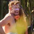EXCLUSIVE: *NO DAILYMAIL ONLINE* Simon Baker Suffers A Cheeky Wetsuit Wardrobe-Malfunction During A Surf Session With Girlfriend Laura May Gibbs In Byron Bay