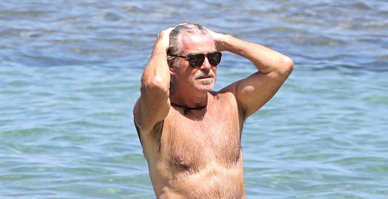EXCLUSIVE: Pierce Brosnan takes off his shirt and takes a dip while in Hawaii